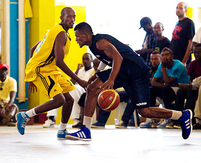 TOP SCORER: KBC's Mike Buzangu, right, drives past his opponent during yesterday's All Stars game at Amahoro indoor stadium. Times  Sport / T. Kisambira
