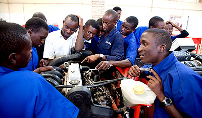 Mechanical engineering students learning engine maintenance tips. Education Times/ Timothy Kisambira.