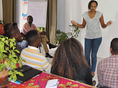 Some of the entrepreneurs who are contesting for the Real Fina Bank Entrepreneurship Award 2013 listen to a colleague as she narrates her experience as a young businesswoman. The New Times/Courtesy