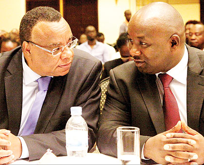 Kenyan Ambassador to Rwanda John Mwangemi (L) chats with Samuel Kirubi, the Equity Bank chief executive, yesterday. A delegation of Kenyan investors were meeting in Kigali to discuss investment opportunities in Rwanda. The New Times/John Mbanda
