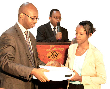 Precieuse Umuhoza (R), a student from Integrated Polytechnic Regional Centre Kigali, receives an award from NISRu2019s Murangwa yesterday.  The New Times/ J. Mbanda.