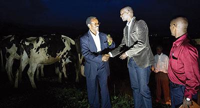 Father Murenzi (left) thanks BRDsu2019 Manzi after receiving the cows.  The New Times / Ben Gasore