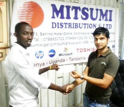 Mitsumi Distribution Rwanda Ltdu2019s Accountant Ashisi Dalwadi (R) hands over a cheque to an RCA official on Monday. Times Sport/Courtesy.