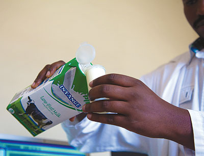 A standards body official measures milk as he prepares to test it. The body has increased drives to educate the public, especially producers and service providers, about key standa....