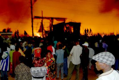 Traders look on as fire consumes Owino Market on Sunday night. Photo: Daily Monitor