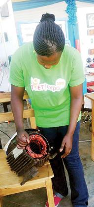 Mu00e9diatrice Mukansanga displays a repaired electric motor. The New Times/Doreen Umutesi