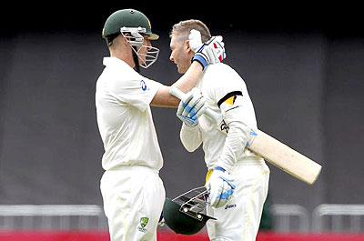 Australia's Brad Haddin congratulates Michael Clarke on scoring a century during the second Ashes Test against England, in Adelaide on Friday. Net photo.