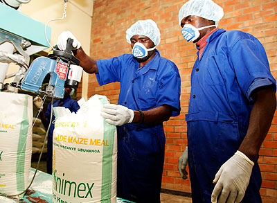Workers package products at a grain milling factory. 