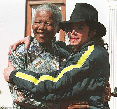 Michael Jackson throws his arms around Mandela at their meeting in South Africa in 1996.