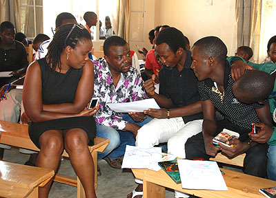 Dominique Mwankumi (squatting) facilitates a workshop in Muhanga. The New Times / Moses Opobo. 