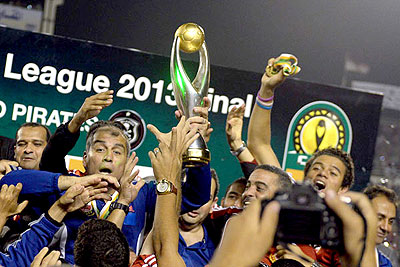 Al-Ahly coach Mohamed Youssef holds up the African Champions League trophy in Cairo. China's Guangzhou Evergrande have vowed to beat Al-Ahly in Saturday's quarter-final match.  Net photo