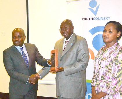 The UN Resident Coordinator, Lamin M. Manneh (center) hands over the award to the Minister of Youth and ICT Jean-Philbert Nsengimana. Looking on is the Permanent Secretary in MYICT, Rosemary Mbabazi. The New Times/Courtesy