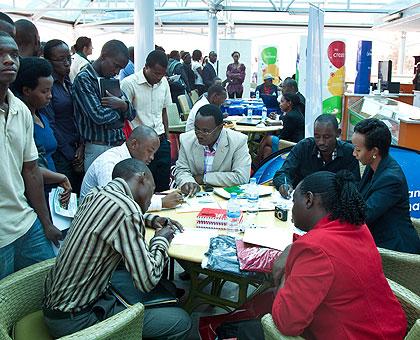 Graduates talk to different companies during last years Job Day. The New Times/Timothy Kisambira