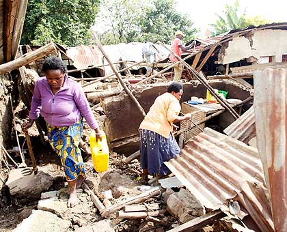 Residents rummage the wreck of their homes to salvage belongings near Cadillac in Kimihurura, Kigali, yesterday. The New Times/ J. Mbanda.