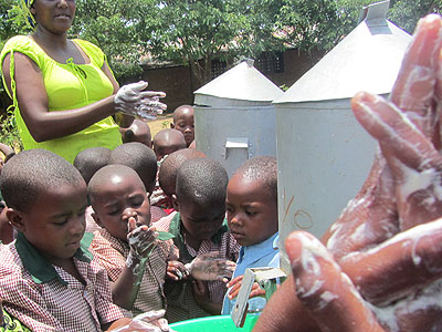 A community education worker leads pupils in a hand washing exercise during the sensitisation campaign in Bugesera. The New Times/Seraphine Habimana