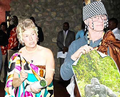 Tourists Joe and Mary Ann McDonald hold a picture of a gorilla. The New Times/ John Mbanda.