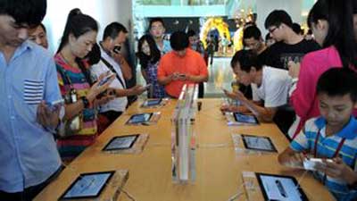 Customers looking at iPhones at an Apple store in China.