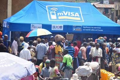 Urwego uses the mVisa platform under its mHose mobile facility. Right, MTN and Tigo mobile money agents at work. The New Times / File