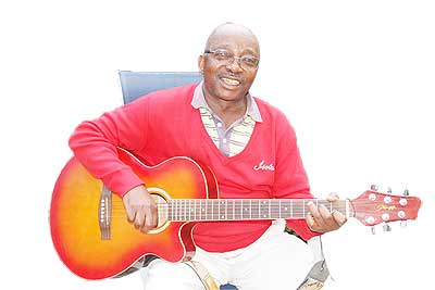 Justin Mwitenawe plays a guitar at his home in Musanze. The New times /  Jean du2019Amour Mbonyinshuti.