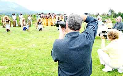 Tourists capture Rwandan cultural dancers in photography near Volcanoes National Park. The New Times/ John Mbanda.