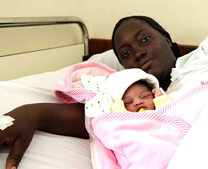 Sinaribanga rests with her newborn Christmas Day bundle at CHUK hospital in Kigali yesterday. The New Times/Timothy Kisambira