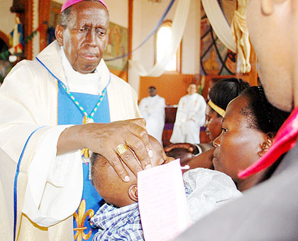 Bishop Mbonyintege baptises a child during the Christmas Mass at Kabgayi Cathedral yesterday. The New Times/Jean-Pierre Bucyensenge