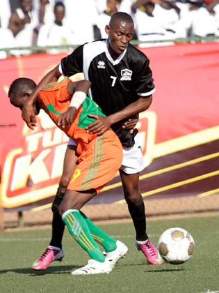 Jean Baptiste Migi Mugiraneza (right) battles for possesion with a Gicumbi opponent early in the season. Saturday Sport/ File