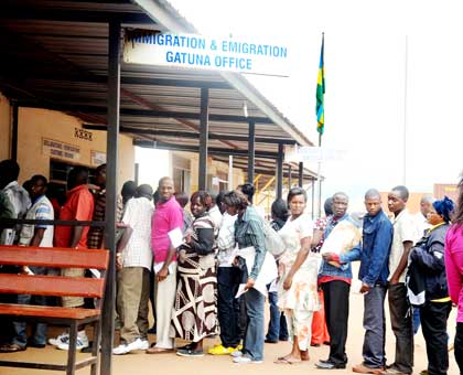 Travellers have their documents stamped at Gatuna border post between Uganda and Rwanda.   The New Times/ File.