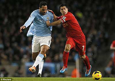 Joleon Lescott (left) and Luis Suarez grapple for possession of the ball. Net photo.
