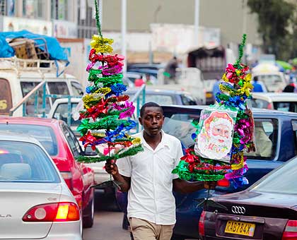 A street vendor hawks Christmas decorations last week. Many vendors see the festive season as a time to mint quick bucks.   The New Times/ File.