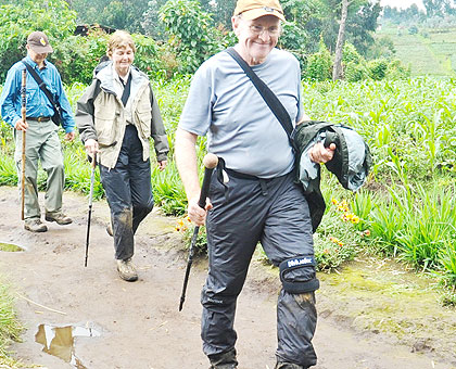 Tourists trek from Virunga National Park. The sector remains the most robust in the economy in terms of foreign earning. The New Times/ File.