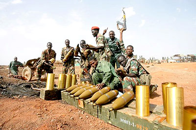 Sudanese soldiers pose next to seized mortar rounds from the Sudanese Peoples Liberation Army (SPLA) of South Sudan