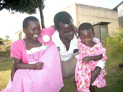 The writer and his nieces, all in new attire on Christmas Day. The New Times/Courtesy