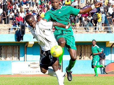 Striker Michel Ndahinduka shields the ball from Kiyovu defender. He netted the winning goal in the 79th minute to send APR on top of the national football league table. Sunday Spor....