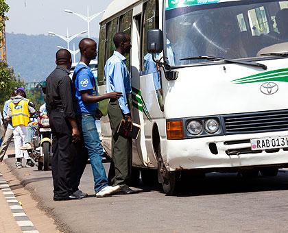 Passengers board a bus. Operators have failed to bring new buses due to financial constraints. Sunday Times/File