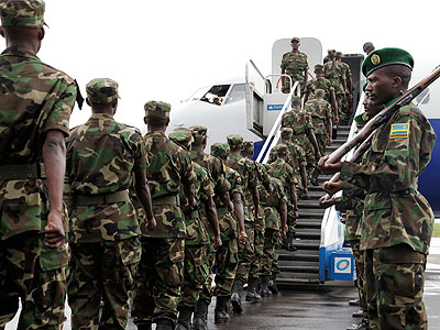RDF servicemen and women board a RwandAir plane en route to Darfur for a UN peace mission on May 13, 2012. The New Times/File