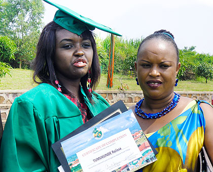 Raissa Tumukunde, 20, and her guardian after the graduation yesterday. One hundred twenty-five orphans, mainly of the 1994 Genocide against the Tutsi, graduated at Agahozo-Shalom Village in various disciplines. . The New Times/ Collins Mwai.