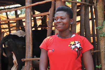 One of the Airtel u2018Birahebujeu2019 promotion winners, Anna Uwamwami, poses with the exotic dairy cow she won last week. The New Times / Peterson Tumwebaze.
