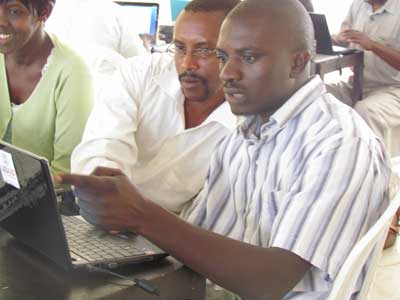 Teachers train on how to use projectors and netbooks. Education Times/Susan Babijja