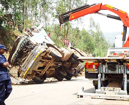 A crane lifts the wreckage of the truck from the scene of accident yesterday. The New Times/ Jean Pierre Bucyensenge.