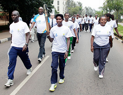 Rwandau2019s 10,000m national champion Claudette Mukasakindi, carries the Queenu2019s Baton on its tour of the City of Kigali on the last day of its relay in Rwanda yesterday.  Saturday Sport / J. Mbanda