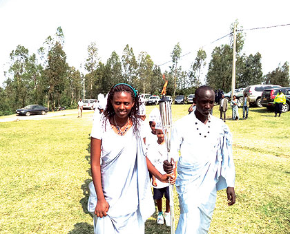Students aged 20, carry the Kwibuka Flame in Kinazi, Ruhango, on Sunday.  The Flame continues its nationwide tour ahead of the 20th anniversary of the 1994 Genocide against the Tutsi. The New Times/ Jean Pierre Bucyensenge.