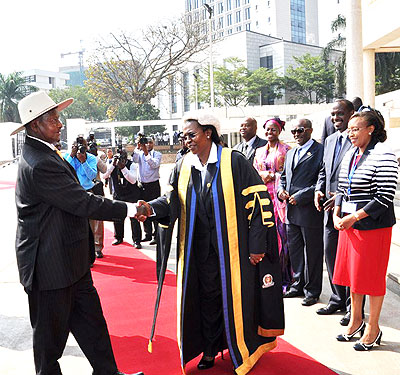 Museveni is welcomed on the steps of Parliament Building by Speaker Zziwa yesterday. The New Times/ G. Muramira.