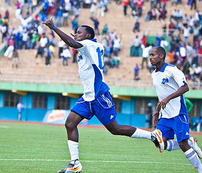 Striker Jerome Sina (left) celebrates after scoring for Rayon Sports in a league match in 2012. Rayon want Rwf3m from Police for his services. Saturday Sport/ File.