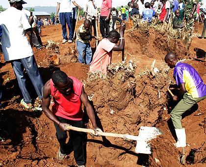 Residents of Bweramvura in Jabana Sector, Gasabo District remove tree stumps to clear a site for the construction of houses for evictees from Tanzania. Sunday Times/ John Mbanda