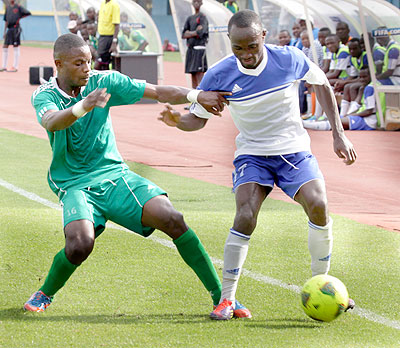 Rayon Sports' striker Cedric Amissi (right) tries to marshal off a challenge by a SC Kiyovu opponent during yesterday's league match. Rayon won 3-1 in an entertaining contest  at Amahoro stadium.  Times Sport / J. Mbanda.