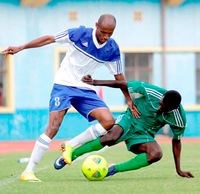 Rayon Sports' midfielder Djamal Mwiseneza, left, is tackled by SC Kiyovu defender during Sunday's league match at Amahoro stadium. Times Sport / J. Mbanda.