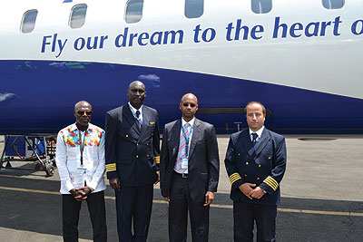L-R: Captain Muvunyi (second, left) poses for a photo with RwandAir chief pilot Marcel Gabou Tirefort, Nyirubutama and Captain Marco, the CRJ fleet manager, after he was given tools of the trade on Tuesday. 