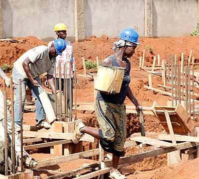 Men and Women work together at a construction site. There is need to address gender imbalance because women can do the same work as men.  The New Times/ File. 