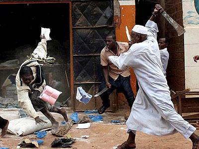 A shopkeeper (right) fights off looters with a machete in Bangui recently. Sunday Times/Internet photo